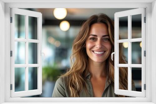 Confident entrepreneur: smiling businesswoman in casual attire poses in modern workspace environment