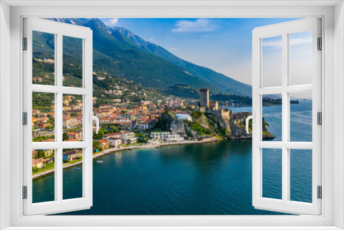 Fototapeta Naklejka Na Ścianę Okno 3D - Aerial View of Scaliger Castle in Malcesine on Lake Garda, Historic Architecture Against Vibrant Town and Blue Waters