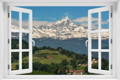 Fototapeta Naklejka Na Ścianę Okno 3D - Monviso mountain range completely covered in snow in contrast with the green hills at the bottom of the valley on a spring day. Saluzzo, Monviso Natural Park, Piedmont, Italy.
