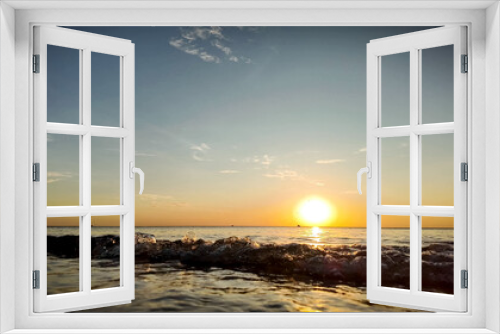 Fototapeta Naklejka Na Ścianę Okno 3D - Tranquil seaside sunrise with gentle waves breaking, perfect for themes of summer travel, relaxation, and World Oceans Day promotions