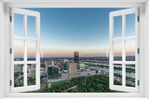 Fototapeta Naklejka Na Ścianę Okno 3D - Aerial panoramic view over Vienna city with skyscrapers, historic buildings and a riverside promenade day to night timelapse in Austria.