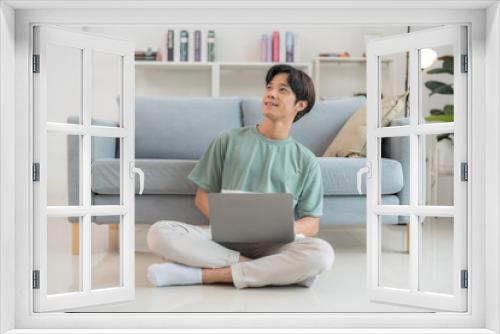 Young man working on laptop at home