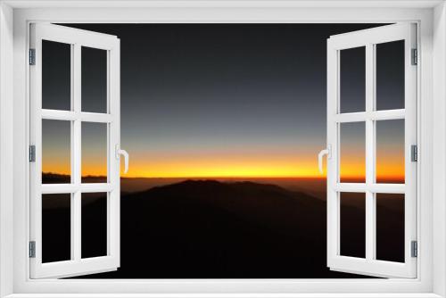 Fototapeta Naklejka Na Ścianę Okno 3D - Breathtaking image of a majestic mountain silhouetted against a vibrant sunset sky