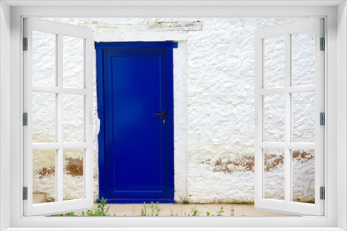 Fototapeta Naklejka Na Ścianę Okno 3D - Old house white wall with new blue door