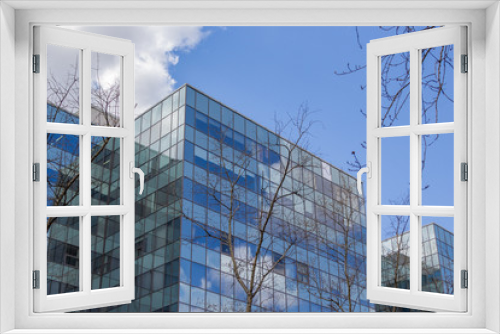 Fototapeta Naklejka Na Ścianę Okno 3D - glass office building against the blue sky