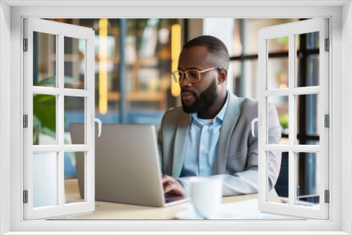 A focused manager sits in a quiet office, having a virtual meeting on a laptop with remote team members, ensuring continuous collaboration and connectivity in a distributed workforce