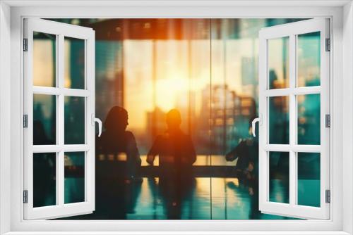 Blurred silhouettes of business professionals in a meeting room, with a large window showing a city skyline