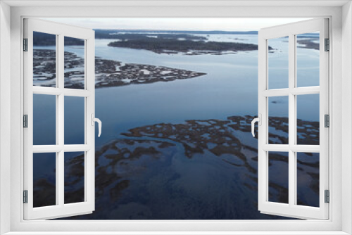Fototapeta Naklejka Na Ścianę Okno 3D - a view of an ocean from an airplane above water and land
