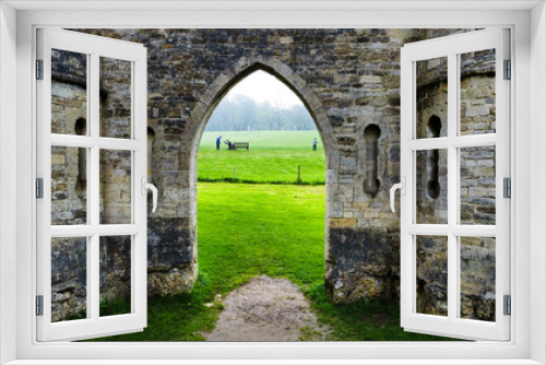 Fototapeta Naklejka Na Ścianę Okno 3D - Castle doorway looking through at some golfers.