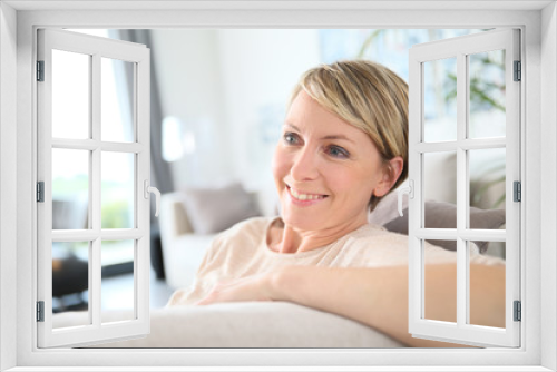 Middle-aged woman relaxing in sofa at home