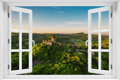 Ruins of a medieval castle Somoska or Somoskoi var on borders of southern Slovakia and Hungary at sunrise time.  .Salgo Castle or Salgo vara in background