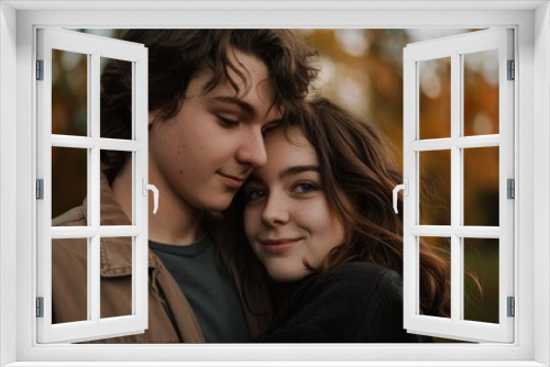 A young couple gazes together in a park