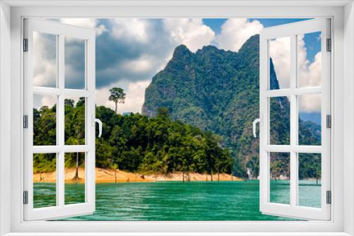 Fototapeta Naklejka Na Ścianę Okno 3D - Tropical jungle and towering limestone cliffs on a large lake (Khao Sok, Thailand)