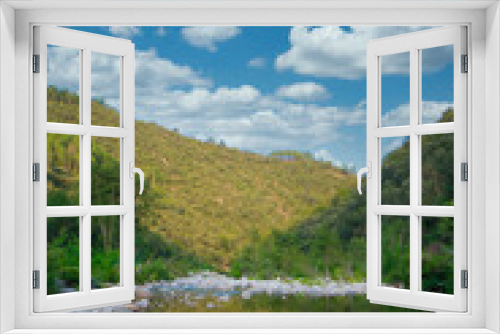 Fototapeta Naklejka Na Ścianę Okno 3D - Beautiful river valley landscape with clear blue sky, fluffy clouds reflecting in water, surrounded by lush greenery