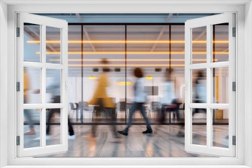 Blurred motion of office workers walking in a modern glass-walled office, capturing the dynamic and busy work environment