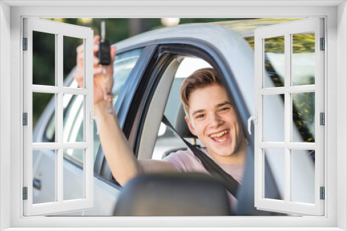 Happy learner driver cheering and holding car key