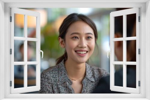 Woman and friend smiling in eatery