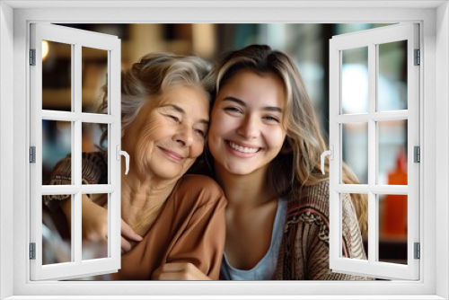 Happy mother and daughter hugging at home, in a cafe or restaurant on Mother's Day