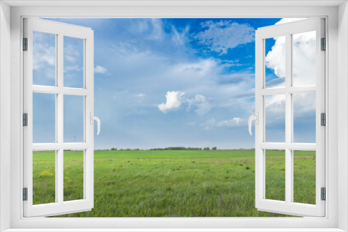 Fototapeta Naklejka Na Ścianę Okno 3D - A vast open field under a clear blue sky, capturing the essence of serenity and tranquility in the springtime.