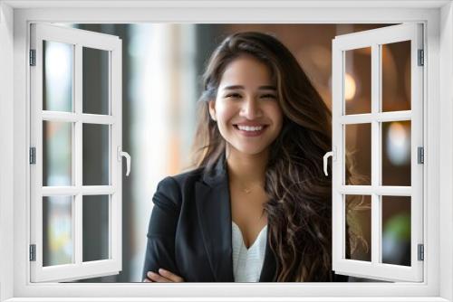 smiling young asian businesswoman in blurred office environment 