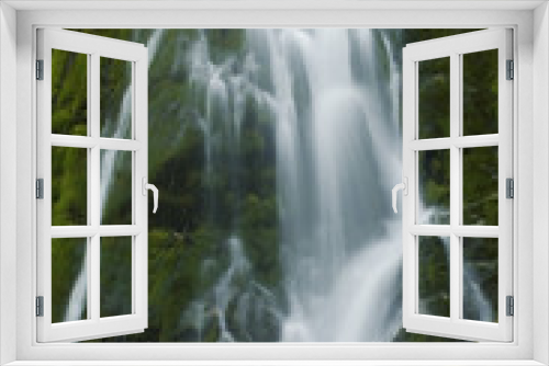 Fototapeta Naklejka Na Ścianę Okno 3D - A beautiful flowing waterfall in the Olympic Rainforest, Washington State USA. 