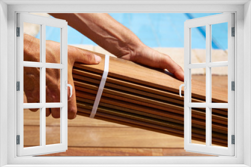 Fototapeta Naklejka Na Ścianę Okno 3D - Ipe deck installation carpenter hands holding wood