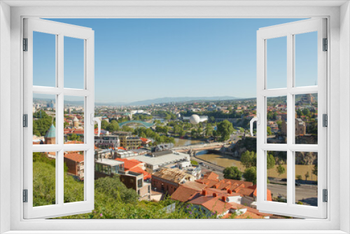 Landscape of old town Tbilisi and river on the background of blue sky and green mountains