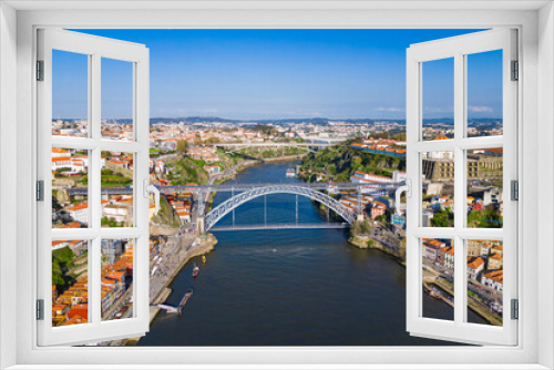 Fototapeta Naklejka Na Ścianę Okno 3D - Cityscape view on the old town in Porto with Luis I Bridge over Douro river in Portugal. Aerial view