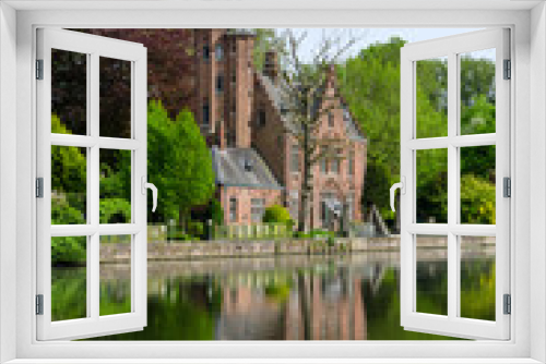 Fototapeta Naklejka Na Ścianę Okno 3D - Flemish style castle reflecting in Minnewater lake in Bruges