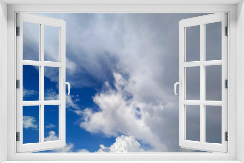 white fluffy clouds on a blue background