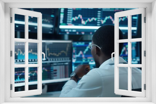 a financial trader analyzing stock market data on multiple screens.