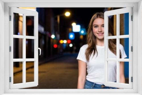 Teenage girl wearing white t-shirt and blue jeans standing in a city alley at night