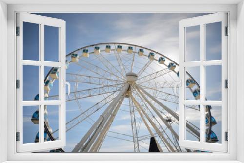 Fototapeta Naklejka Na Ścianę Okno 3D - Ferris wheel under blue dramatic skies