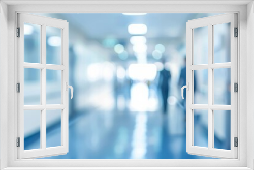 A modern healthcare environment is shown through a blurred hospital corridor with bright lights, indicating busyness