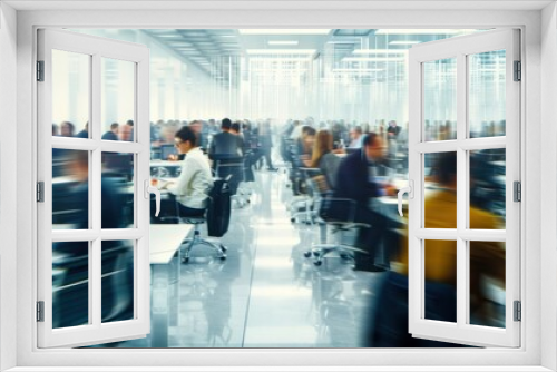 Blurred image of business people working in a large, modern office space with glass walls and white interiors.