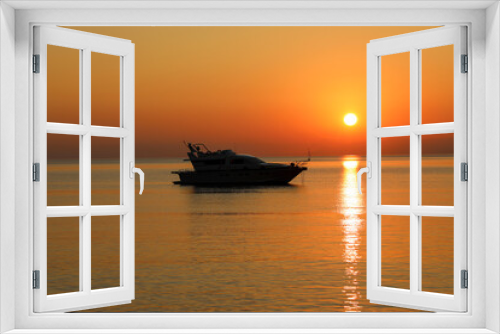 Fototapeta Naklejka Na Ścianę Okno 3D - Yacht at sea early in the morning against the backdrop of the rising sun