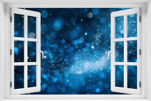 Abstract blue bokeh background with a soft glow and blurred lights.  Photo perfect for a festive or celebratory design.