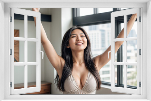 A young Asian woman stretching in a bright room