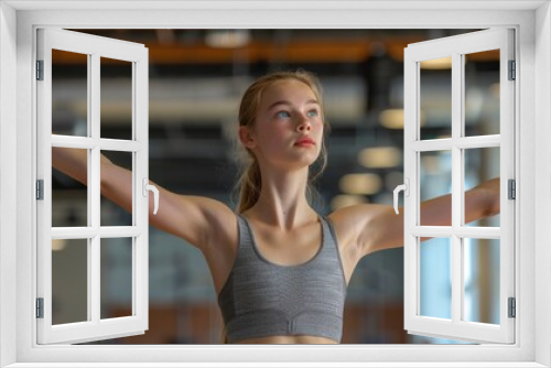 A young woman practicing ballet in a dance studio