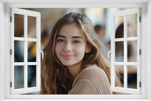 contented female student attending a university class while focusing on the camera