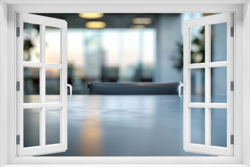 Modern office interior with a focus on a black conference table and blurred background with large windows and natural light.