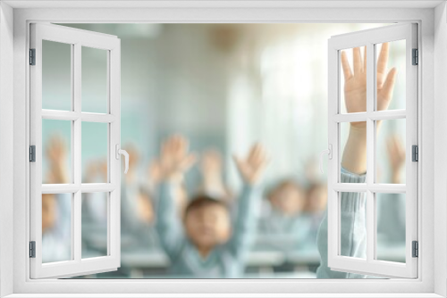 Students raising hands in a classroom, participating actively in a lesson, blurring in background for depth of field effect.