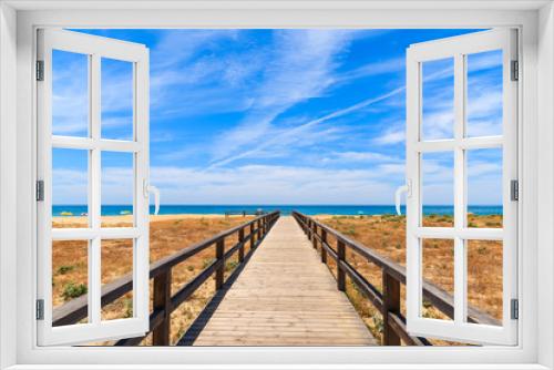 Fototapeta Naklejka Na Ścianę Okno 3D - Walkway to sandy beach in Armacao de Pera coastal town, Algarve region, Portugal