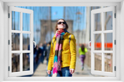 Young woman sightseeing on Brooklyn Bridge