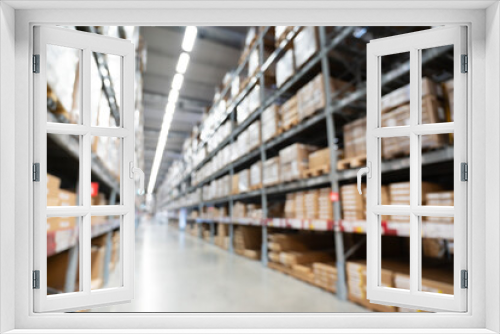 Abstract Blurred Storage Warehouse Logistics. Blurred industrial warehouse with goods and products. Logistics, business, delivery, services concept. Defocused industrial storehouse interior.