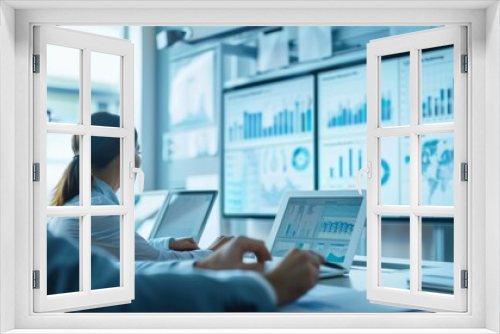 A team in a boardroom reviewing financial graphs on a large whiteboard.