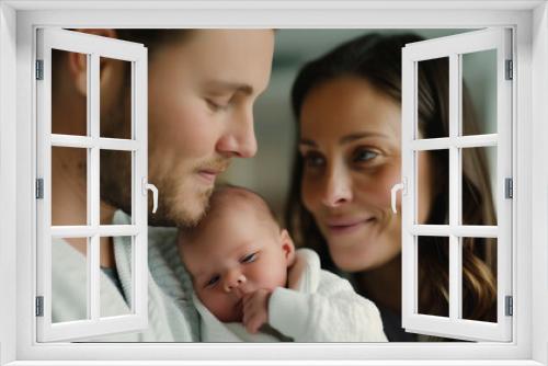 '' new parents looking lovingly at their newborn baby in a maternity hospital room filled with soft light 