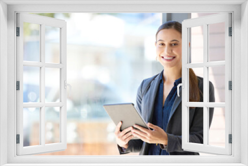 Portrait, happy and business woman with tablet by property for investment, real estate or home loan. Realtor, technology and female person with sale for networking, communication or open house