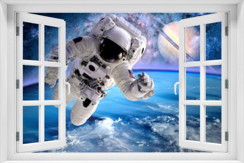 Fototapeta Naklejka Na Ścianę Okno 3D - Astronaut spaceman outer space planet saturn earth universe. Elements of this image furnished by NASA.