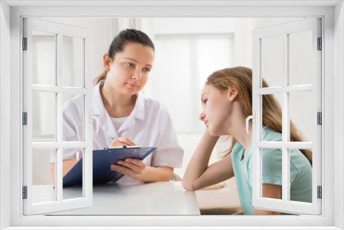 Doctor Comforting Patient At Table